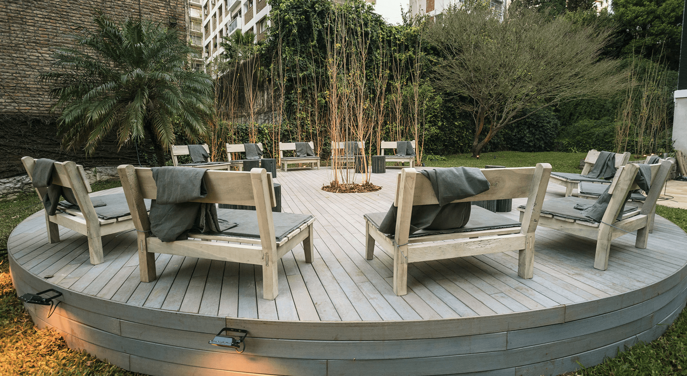 Free Framer Template - A cozy interior of a cafe with wooden tables, chairs, and potted plants, creating a warm atmosphere.