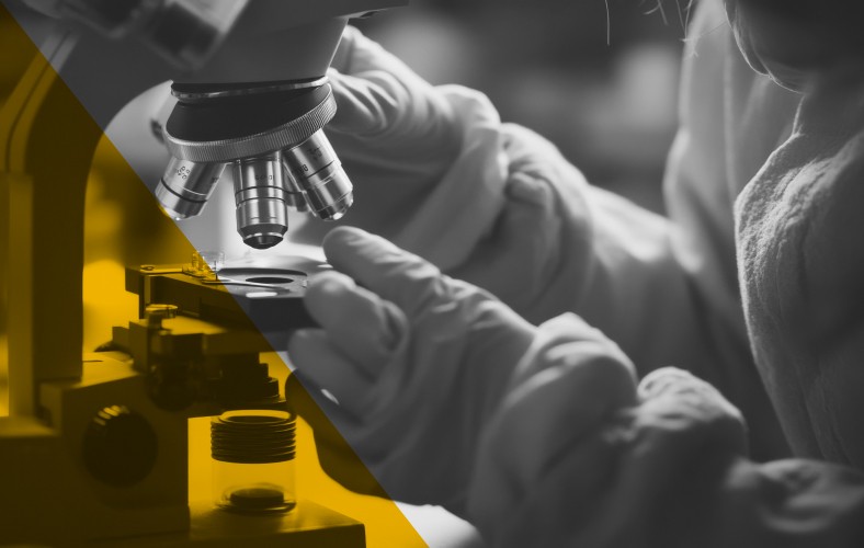 Scientist analyzing samples under a microscope, representing AI-powered research and regulatory intelligence