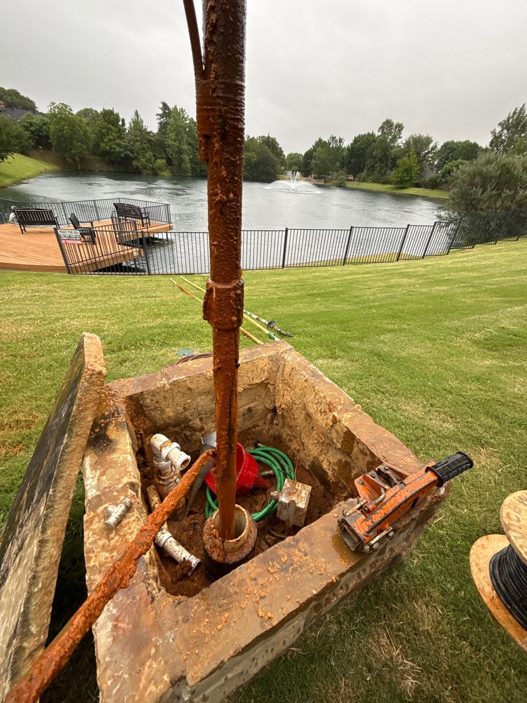 Submersible pump pulled from a Grapevine, TX well showing iron bacteria slime and rust buildup before chlorine shock and rehab