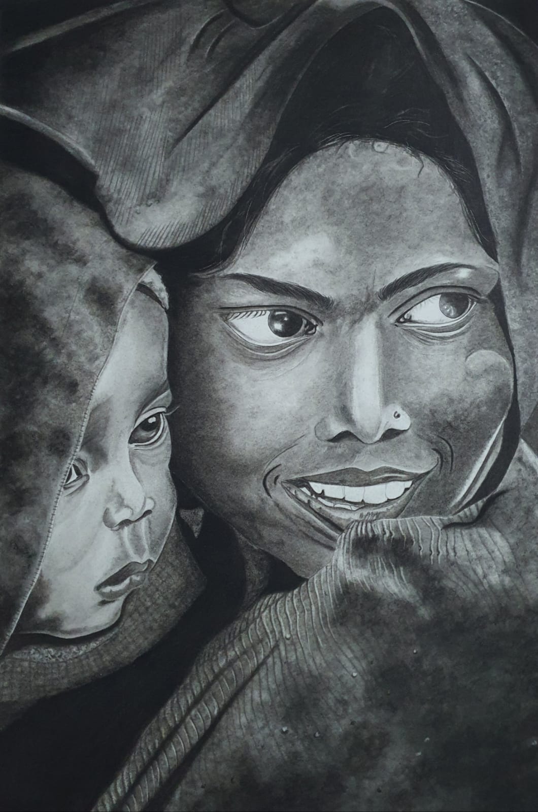 Charcoal artwork of a woman and child with expressive eyes and dramatic shading.