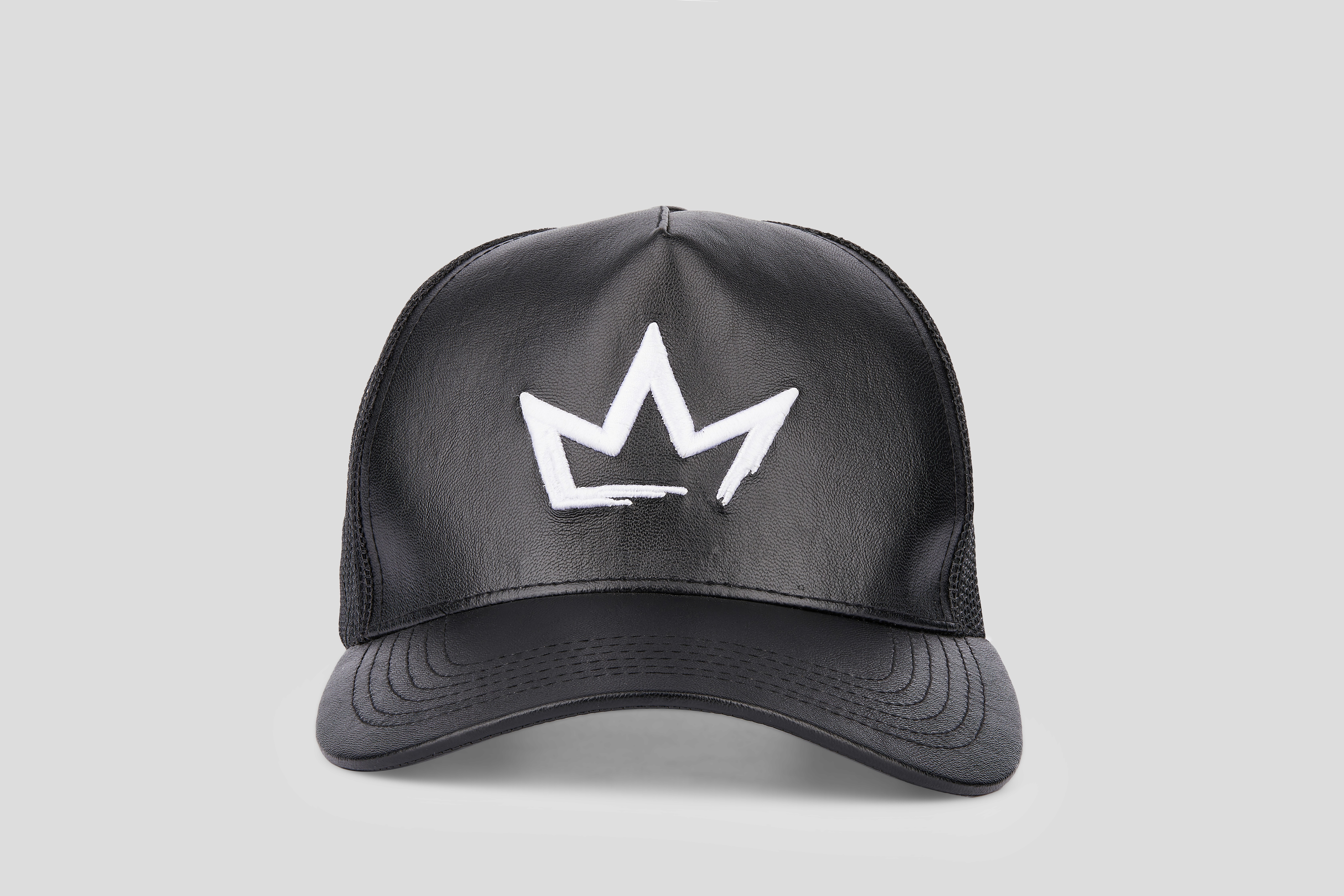 A colorful patchwork baseball cap featuring vibrant floral embroidery in shades of red, orange, blue, and green, set against a plain light gray background.