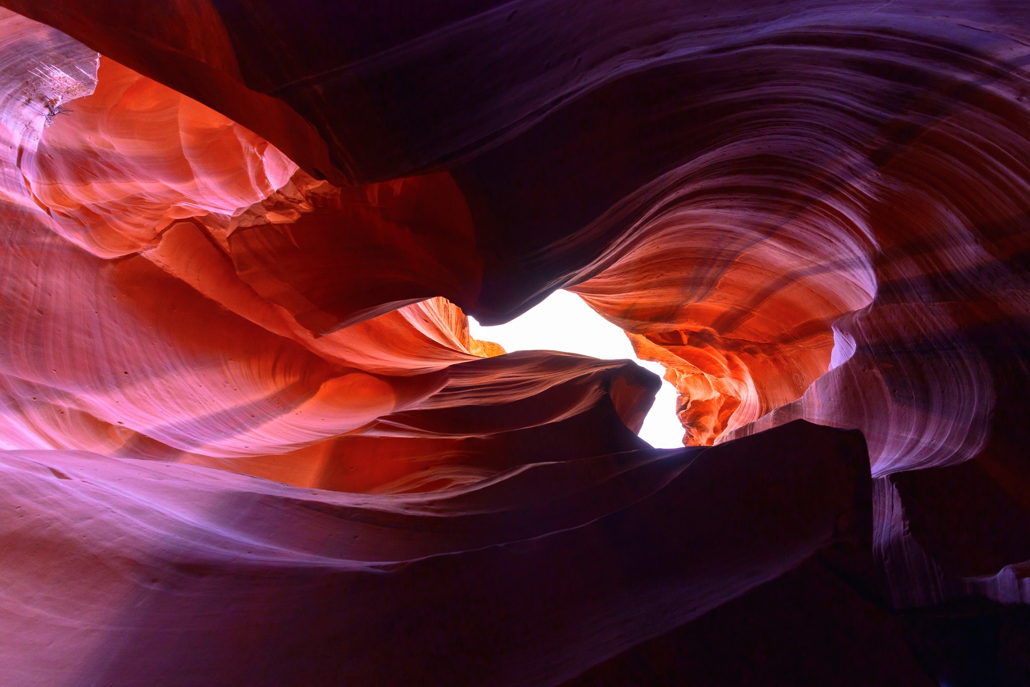 Colorful canyon formation with bright light opening at the top