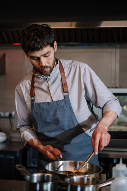 Portrait of a man stirring a pan