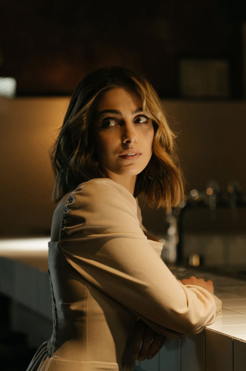 Portrait of a woman standing at a bar