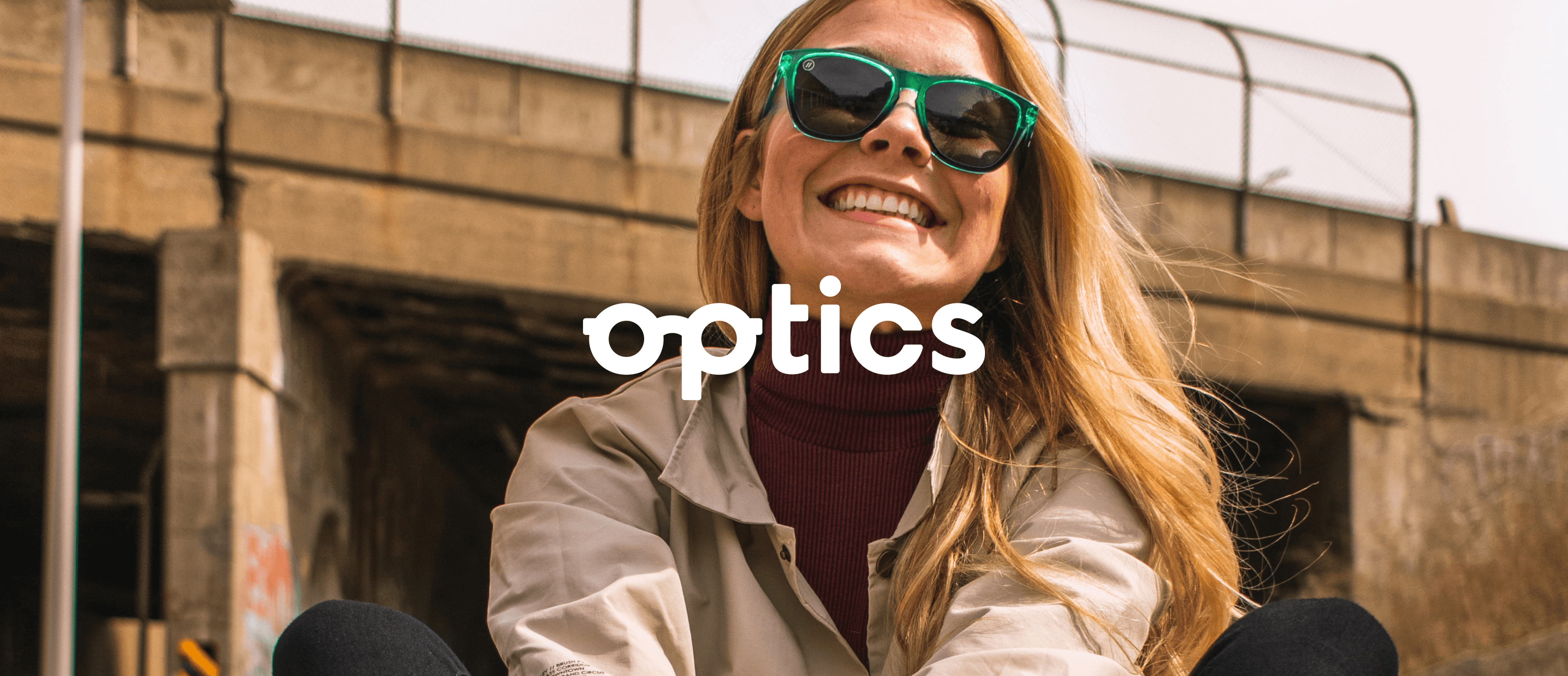 Optics brand photo of girl smiling with sunglasses