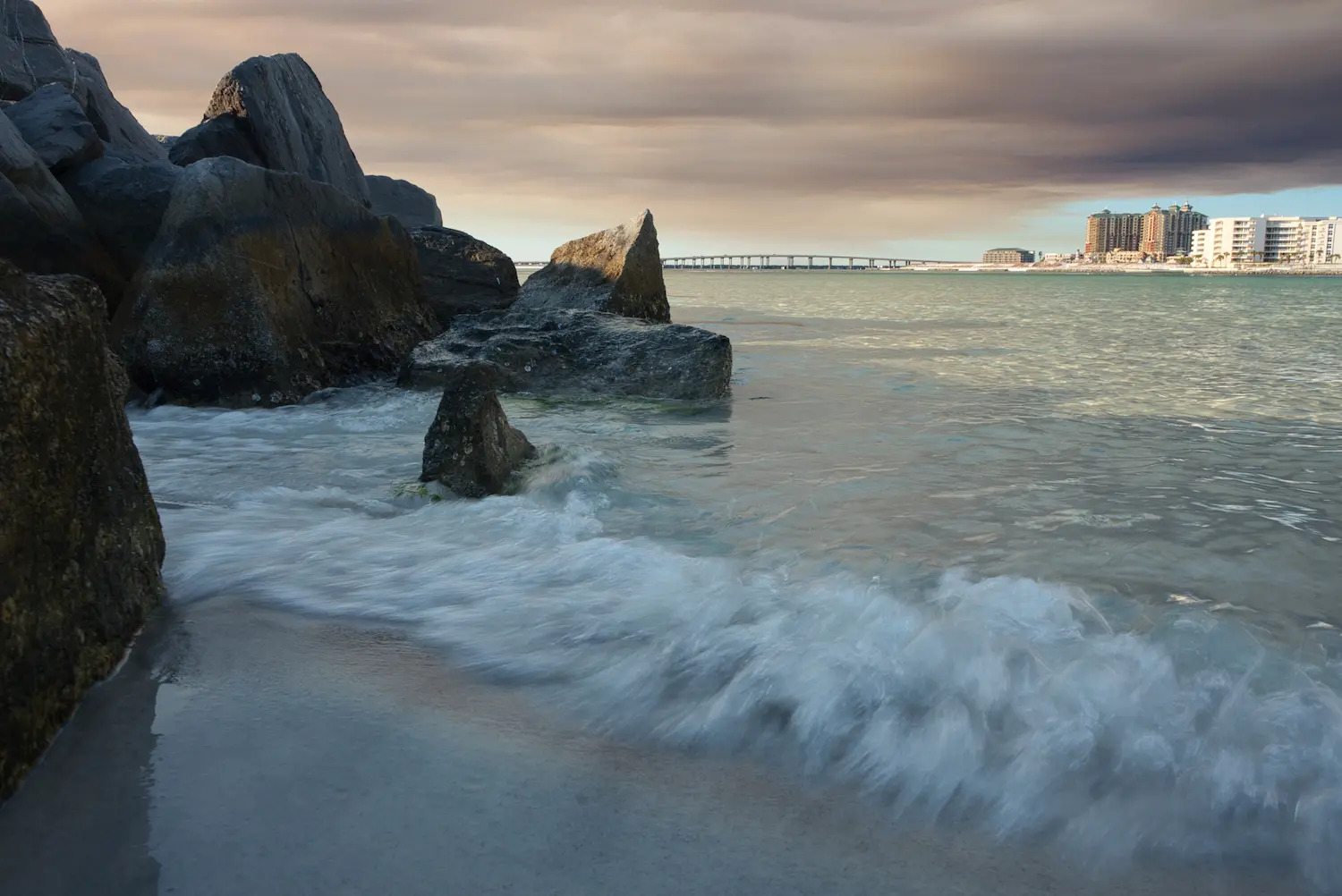 long exposure shot taken of waves crashing on jetties in destin fl at destin pass taken by professional photographer