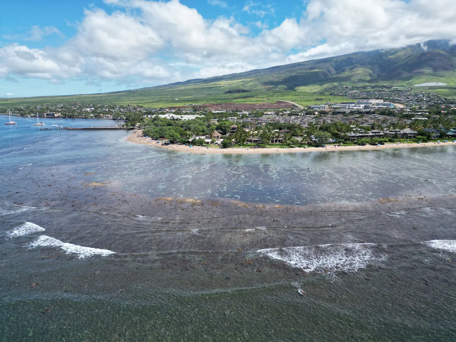 aerial perspective from drone taken over the water with west maui lahina in the background taken by professional photographer