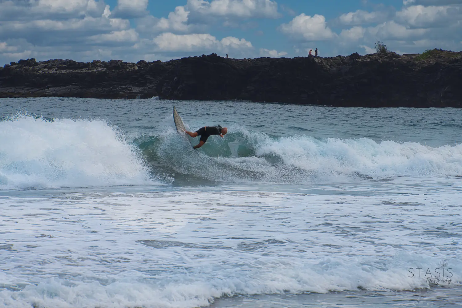 person surfing in a wave taken by professional photographer