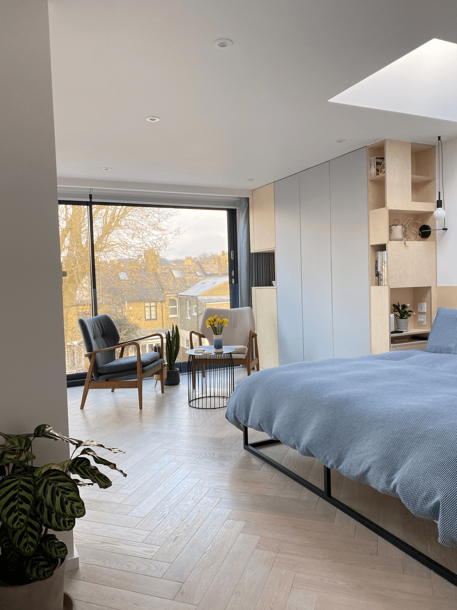 A white bed in a South West London bedroom with a balcony.	