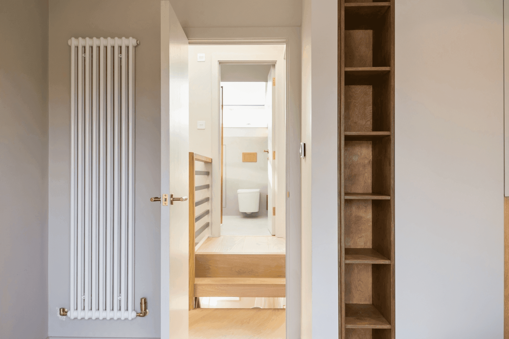 A loft conversion featuring a radiator and bookshelves.	