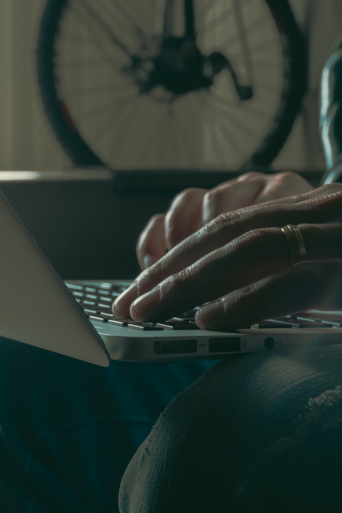 person writing on her computer