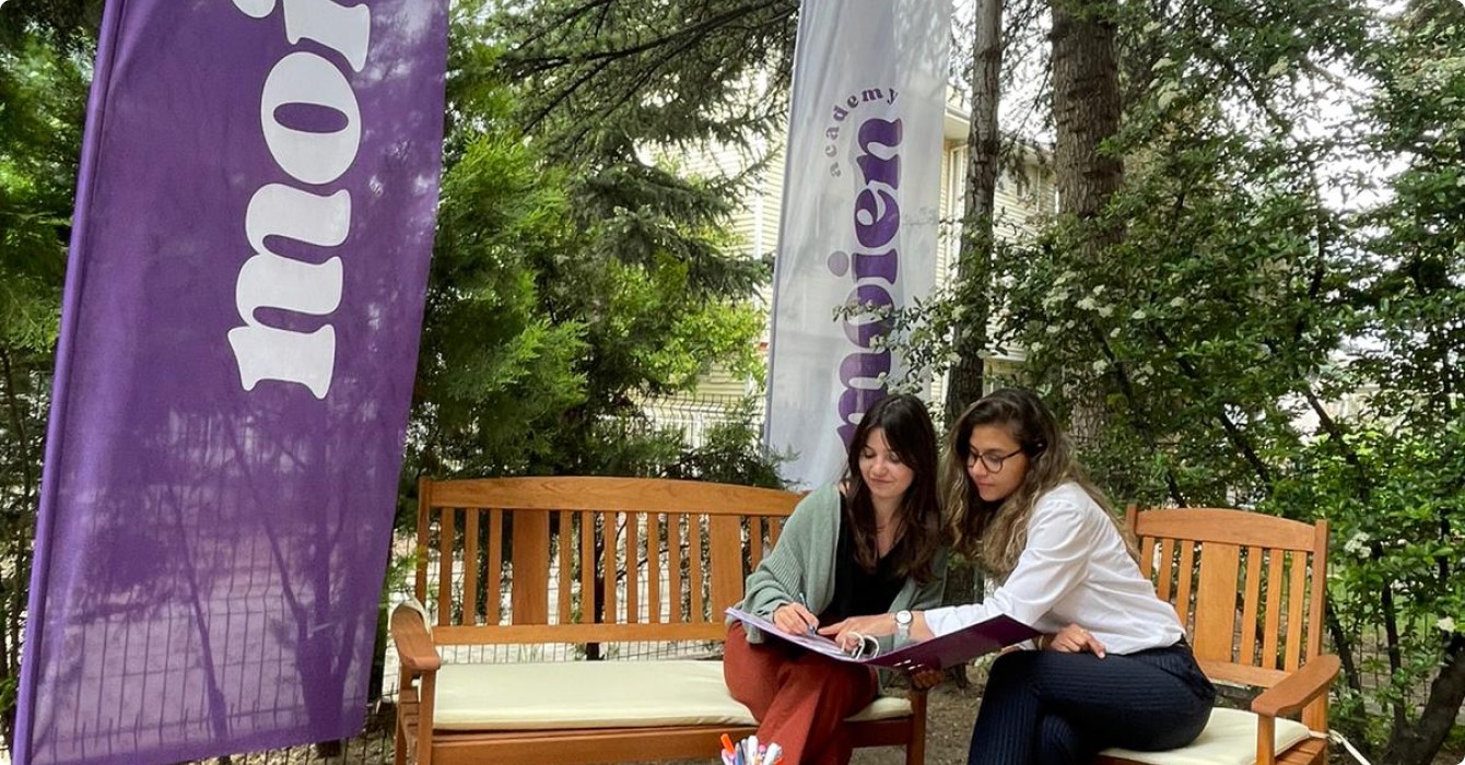 two people studying on a bench