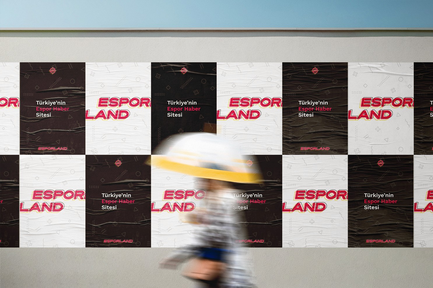 a woman walking past posters of Esporland