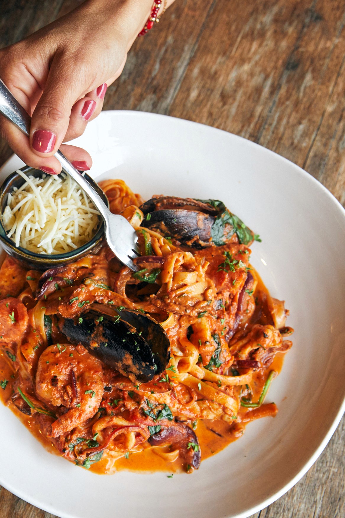 customer eating seafood fetuccini