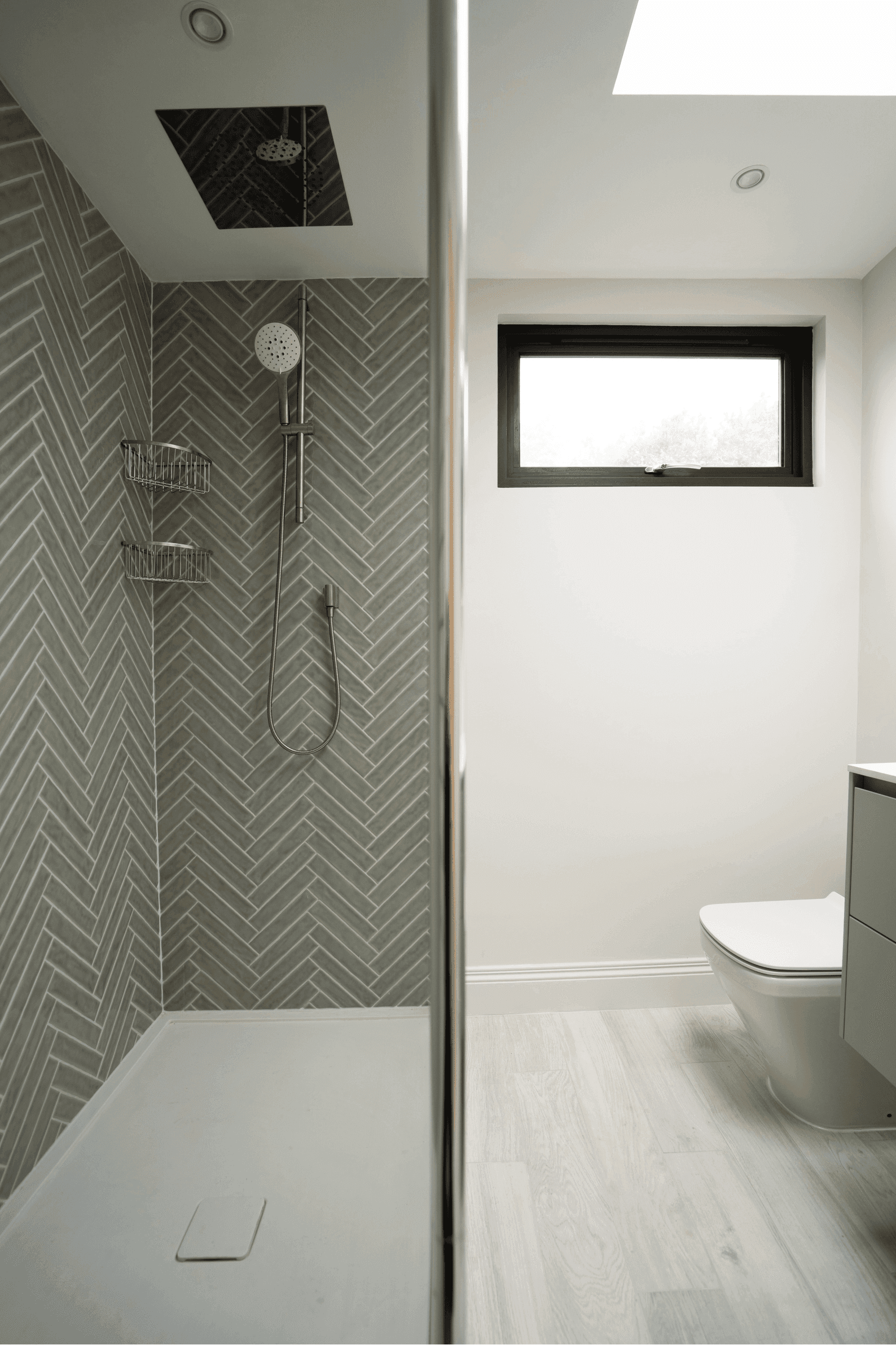 A modern bathroom in South East London with a shower and toilet.	