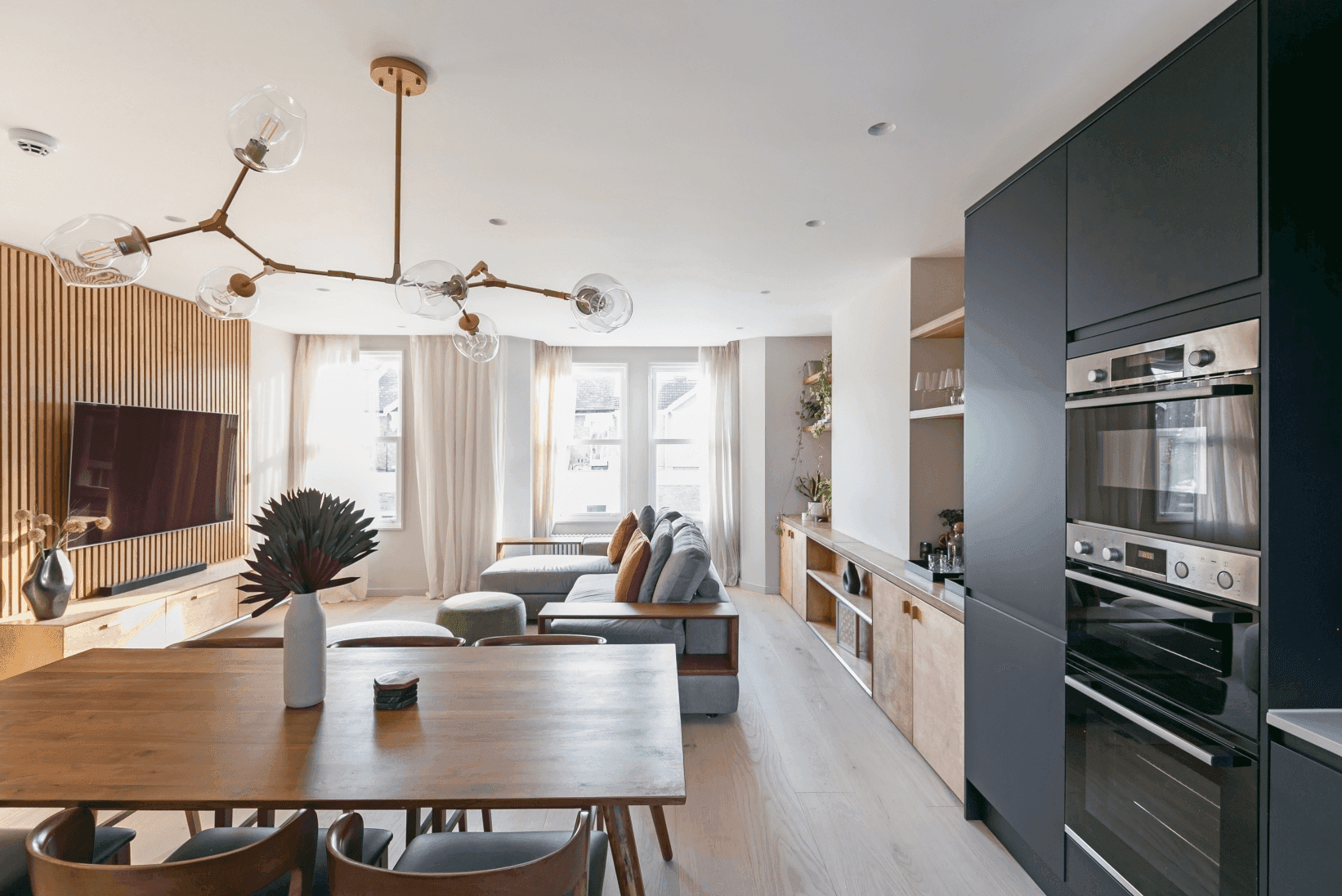 A living room furnished with a table and chairs for a loft in South East London.	