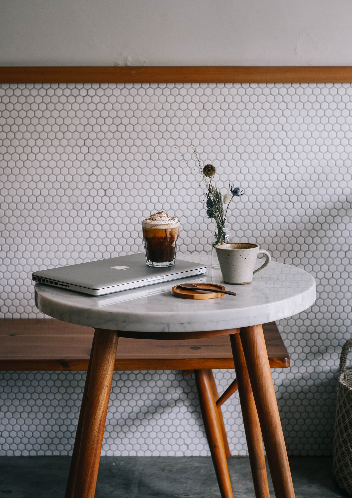 Image of coffee and a computer on a small table