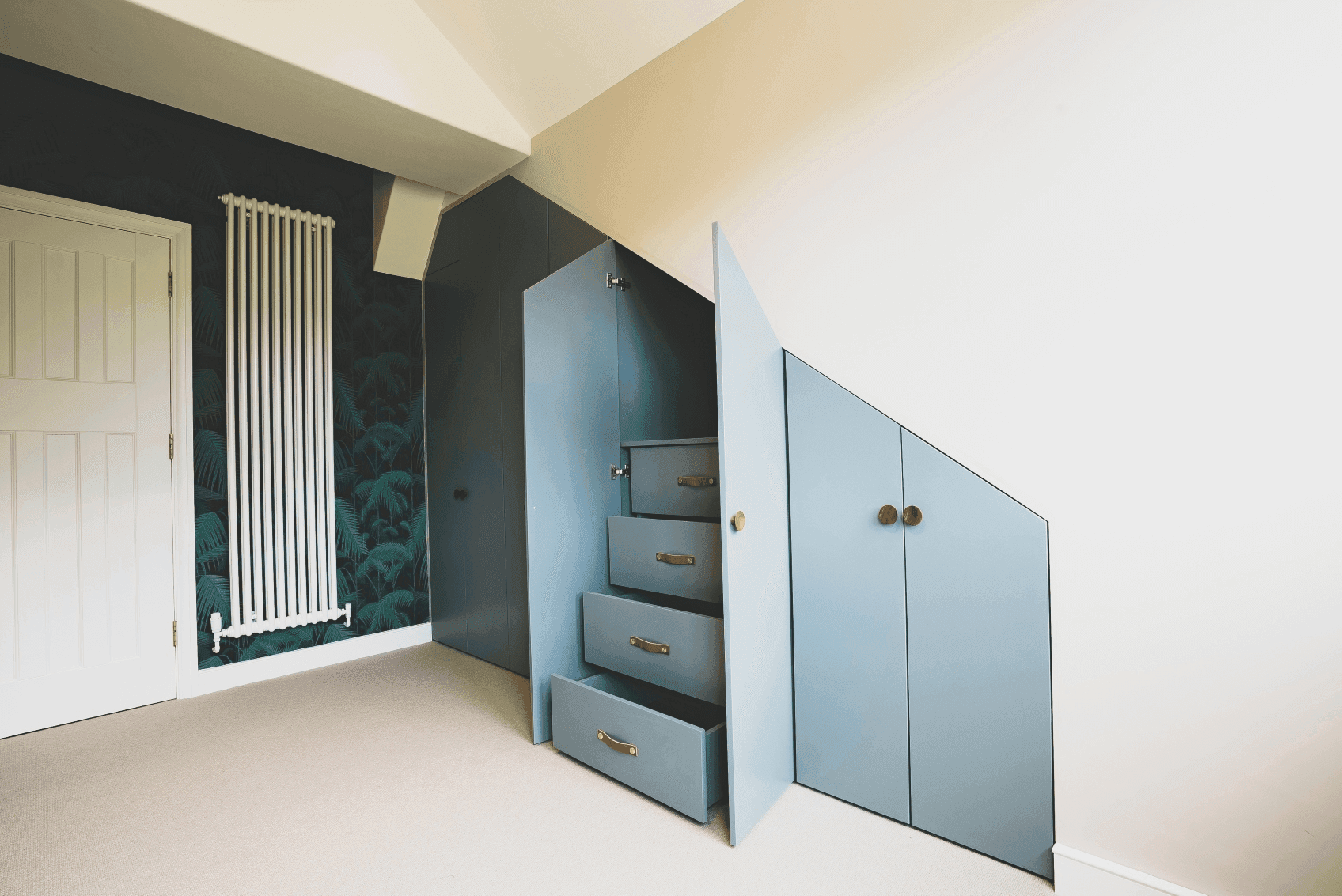 A room in South London with storage space provided by a closet and drawers, built by a professional loft company.