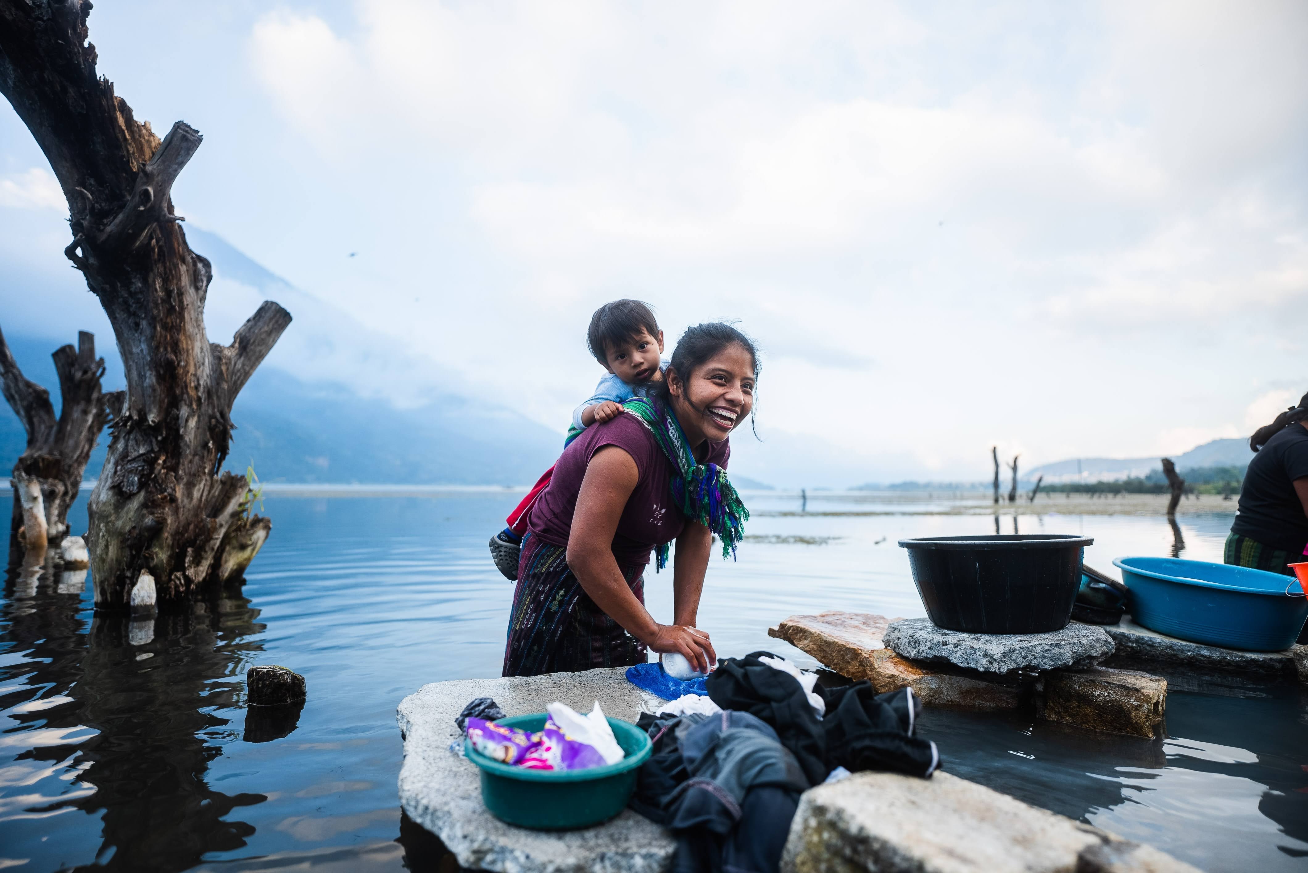 mother and child in a body of water smiling