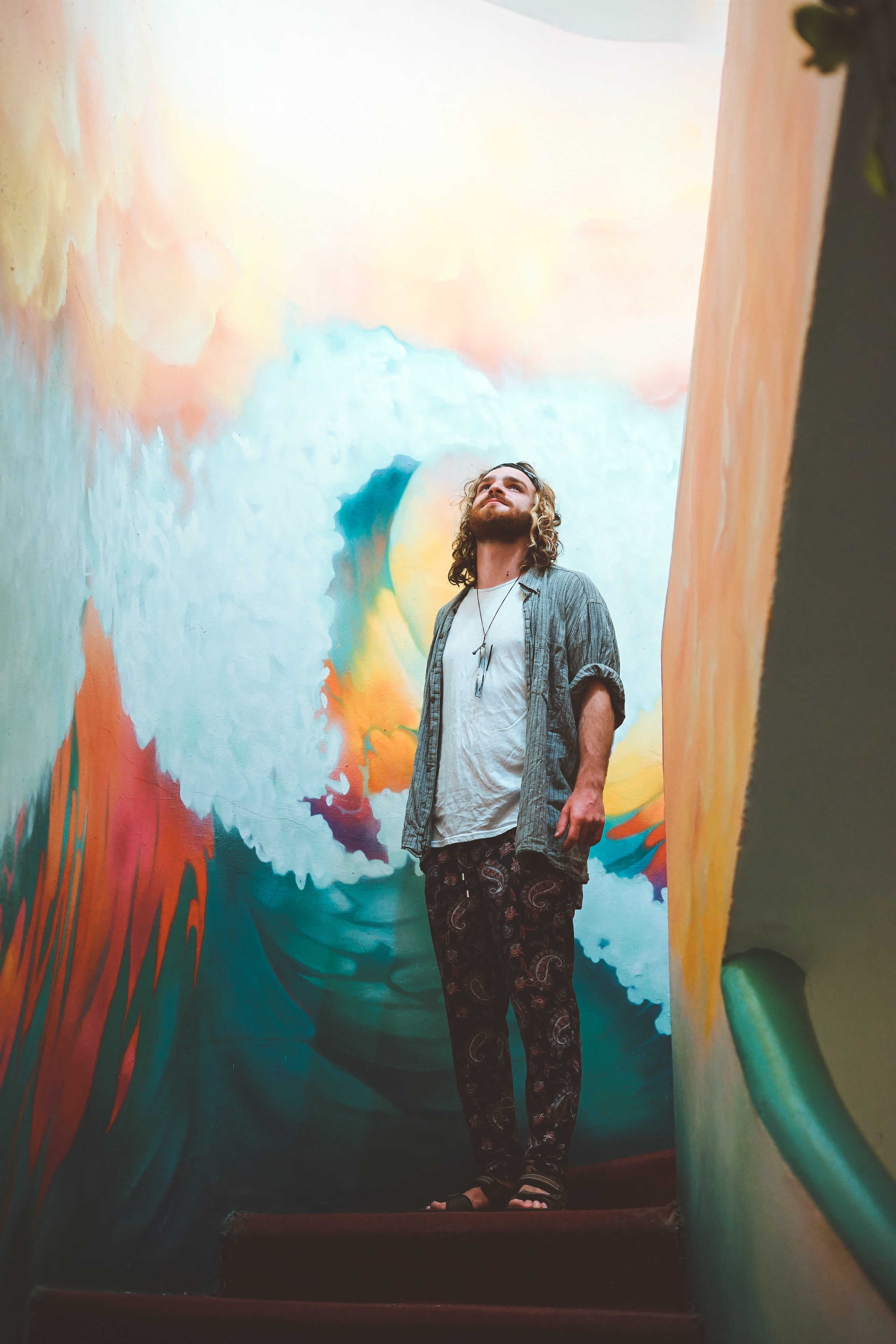 man standing in front of a colorful wall