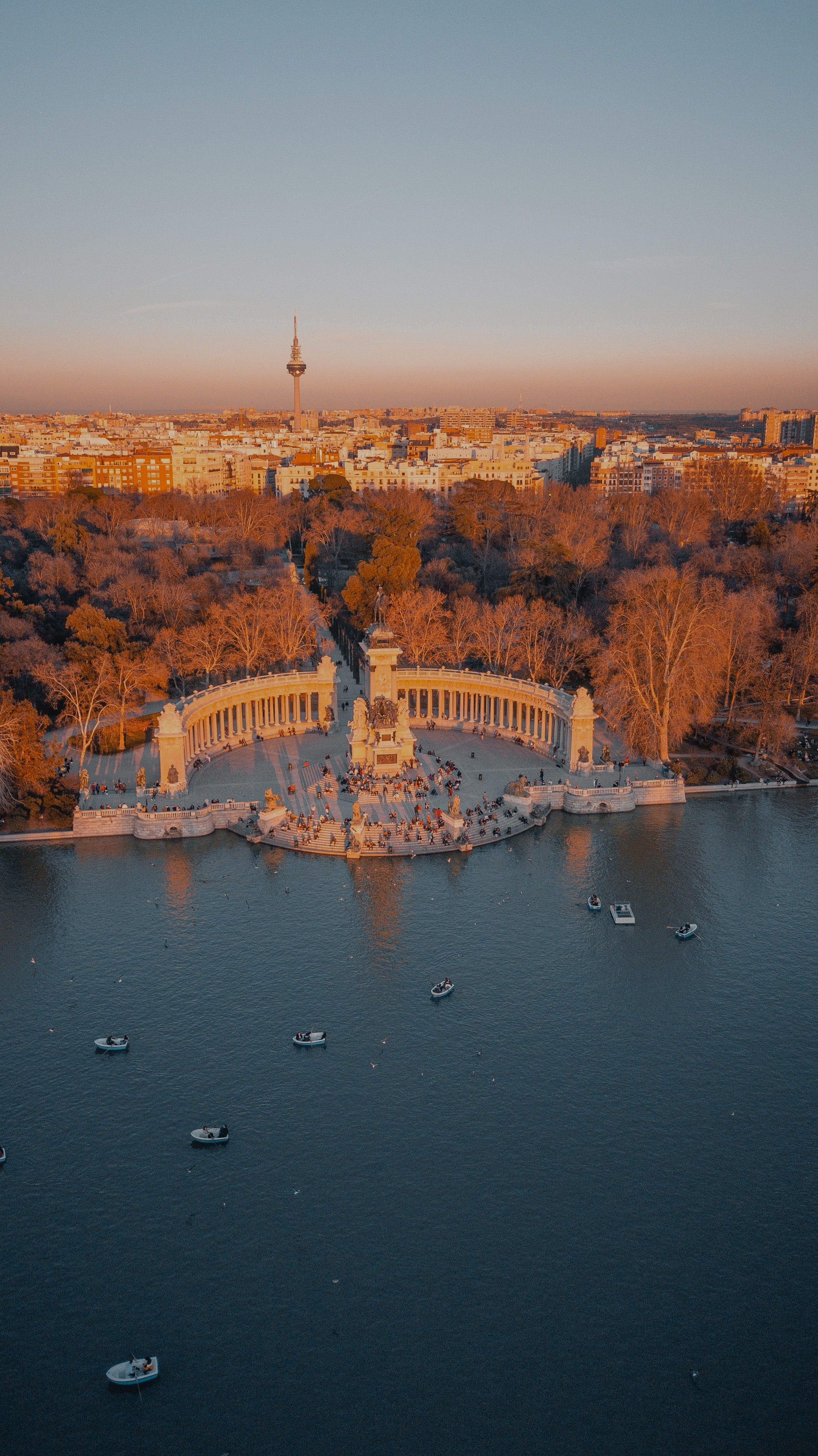 aerial view of monument with forest on one side and a lake on the other