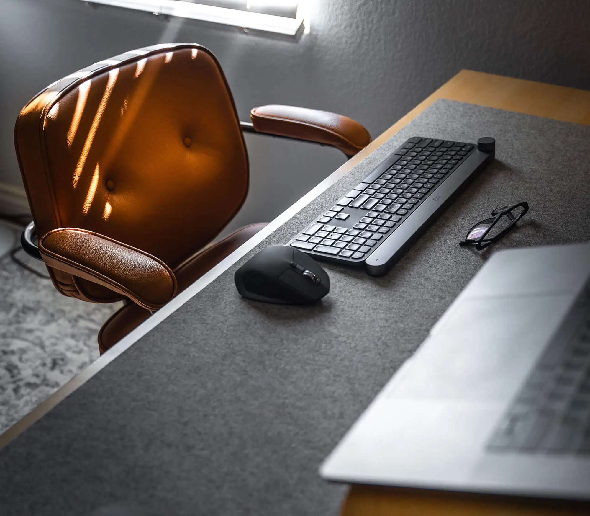 Desk with keyboard and brown chair