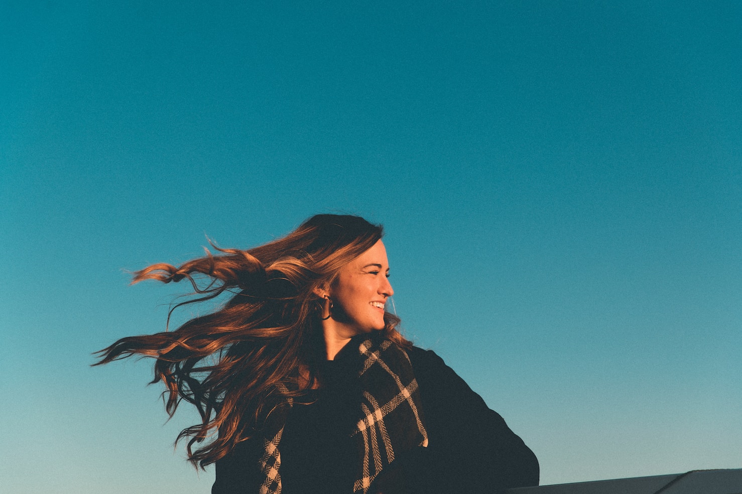 a girl with wind blowing her hair