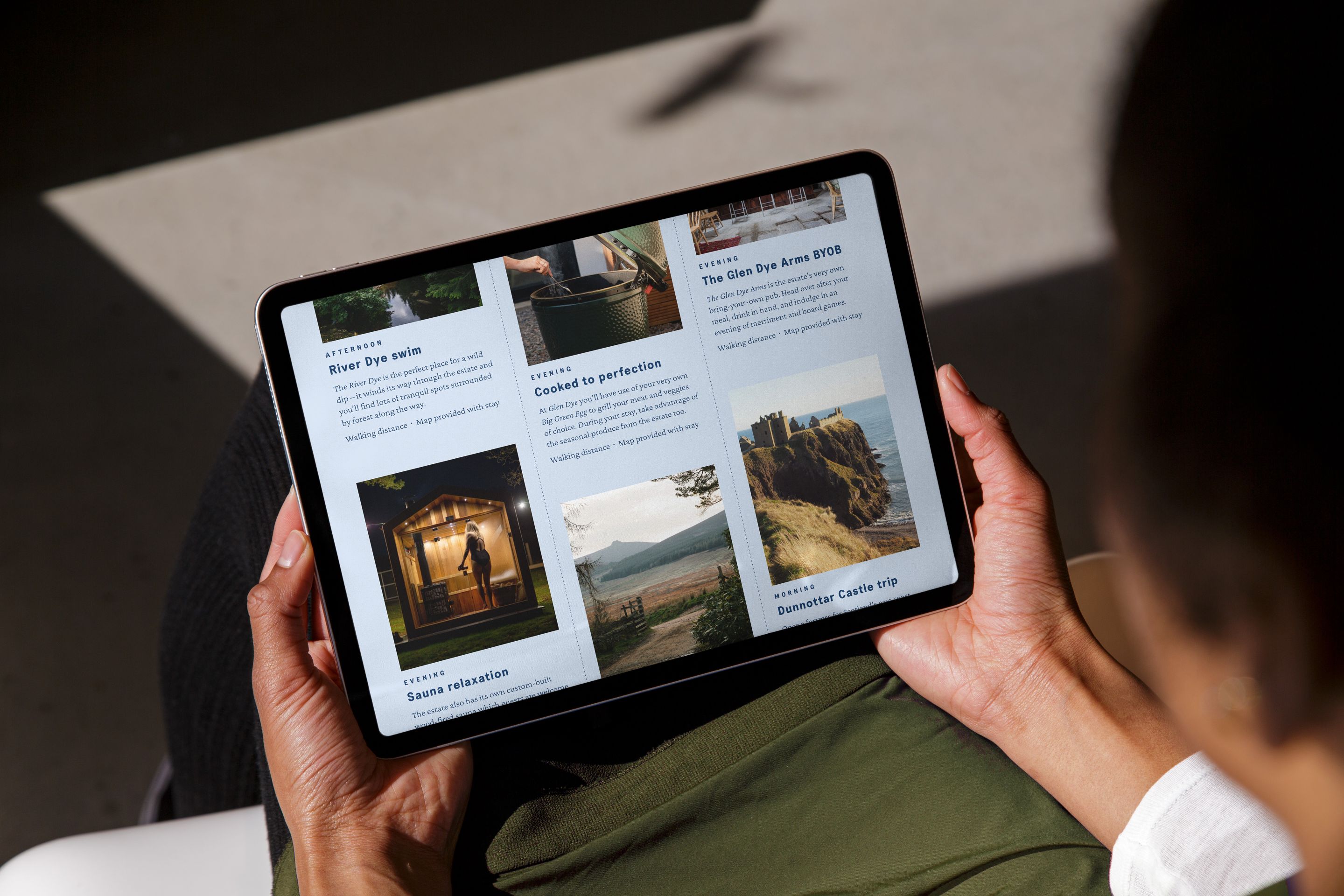 A person holding an iPad showing the Hour directory website